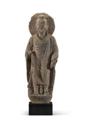 A RARE AND MONUMENTAL INSCRIBED GREY SCHIST FIGURE OF BUDDHA