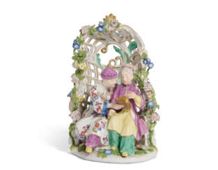 A MEISSEN PORCELAIN GROUP OF A CHINOISERIE COUPLE SEATED IN AN ARBOUR