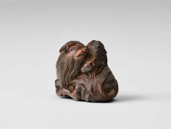 A CARVED WOOD NETSUKE OF A PARENT AND CHILD GOAT - photo 2