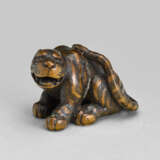 A CARVED WOOD NETSUKE OF A TIGER - фото 1