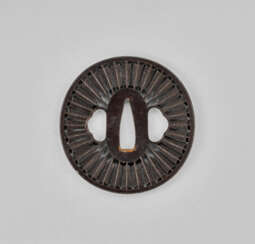 AN IRON TSUBA WITH ARROW