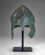 Defensive weapons. A GREEK BRONZE CHALCIDIAN HELMET