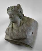 Overview. A ROMAN BRONZE SHIP FITTING WITH A BUST OF ARIADNE