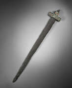 Defensive weapons. A PONTIC IRON SPATHA WITH A GEM-INLAID BRONZE HANDLE