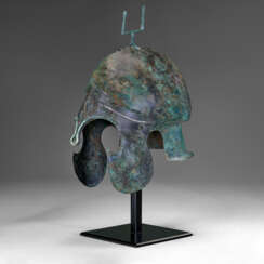 A GREEK BRONZE CHALCIDIAN HELMET WITH SILVER OVERLAYS