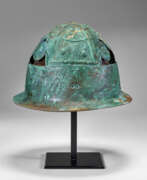 Leather. A PICENIAN BRONZE HELMET WITH LEATHER AND BASKETRY LINING