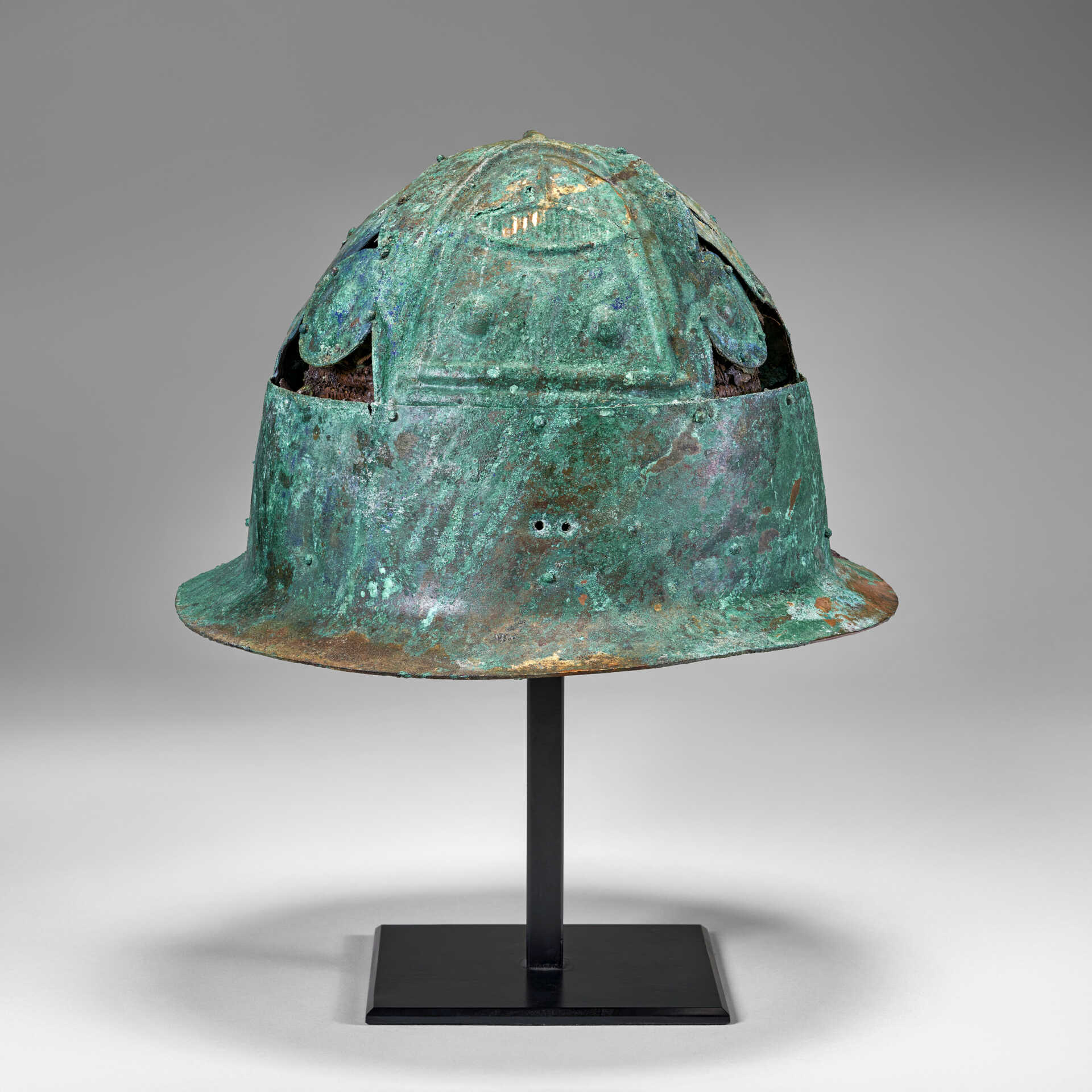 A PICENIAN BRONZE HELMET WITH LEATHER AND BASKETRY LINING