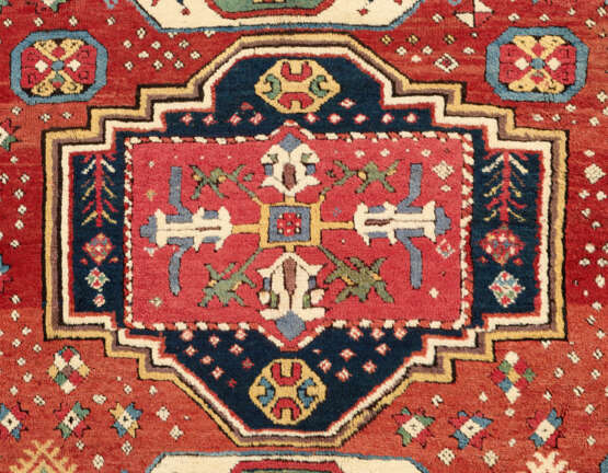 A TRIPLE-MEDALLION KAZAK RUG - photo 2