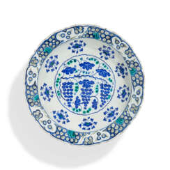 A LARGE IZNIK POTTERY &#39;GRAPE&#39; DISH