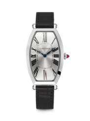 CARTIER. A RARE PLATINUM LIMITED EDITION TONNEAU SHAPED WRISTWATCH