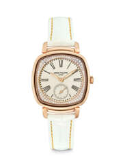 PATEK PHILIPPE. A LADY’S ELEGANT 18K PINK GOLD AND DIAMOND-SET CUSHION SHAPED WRISTWATCH