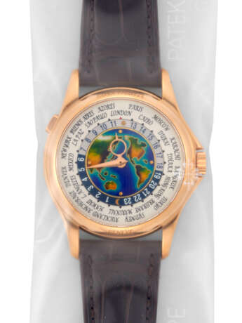 PATEK PHILIPPE. A RARE 18K PINK GOLD AUTOMATIC WORLD TIME WRISTWATCH WITH CLOISONN&#201; ENAMEL DIAL, SINGLE SEALED - photo 1