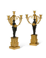 A PAIR OF EMPIRE ORMOLU AND PATINATED BRONZE THREE-LIGHT CANDELABRA