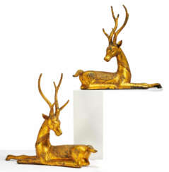 PAIR OF LYING METAL STAGS AS TEMPLE SCULPTURES