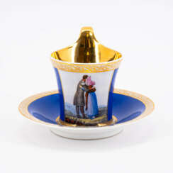 KPM. Tasse und Untertasse mit sich umarmendem Paar und SinnspruchKPM. PORCELAIN CUP AND SAUCER WITH AN EMBRACING COUPLE AND APHORISM