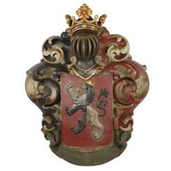 Large, carved, wooden coat of arms depicting a knight`s helmet topped with a crown. 19th century.