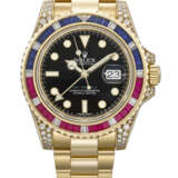 ROLEX. A RARE AND DAZZLING 18K GOLD, DIAMOND, RUBY AND SAPPHIRE-SET AUTOMATIC DUAL TIME WRISTWATCH WITH SWEEP CENTRE SECONDS, DATE AND BRACELET - photo 1