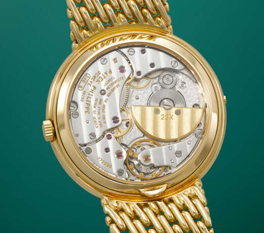 PATEK PHILIPPE. A RARE AND ELEGANT 18K GOLD AUTOMATIC PERPETUAL CALENDAR WRISTWATCH WITH MOON PHASES, 24 HOUR, LEAP YEAR INDICATION AND BRACELET - photo 4