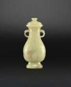 Jade. AN ARCHAISTIC YELLOW AND RUSSET JADE ‘DRAGON’ VASE AND COVER