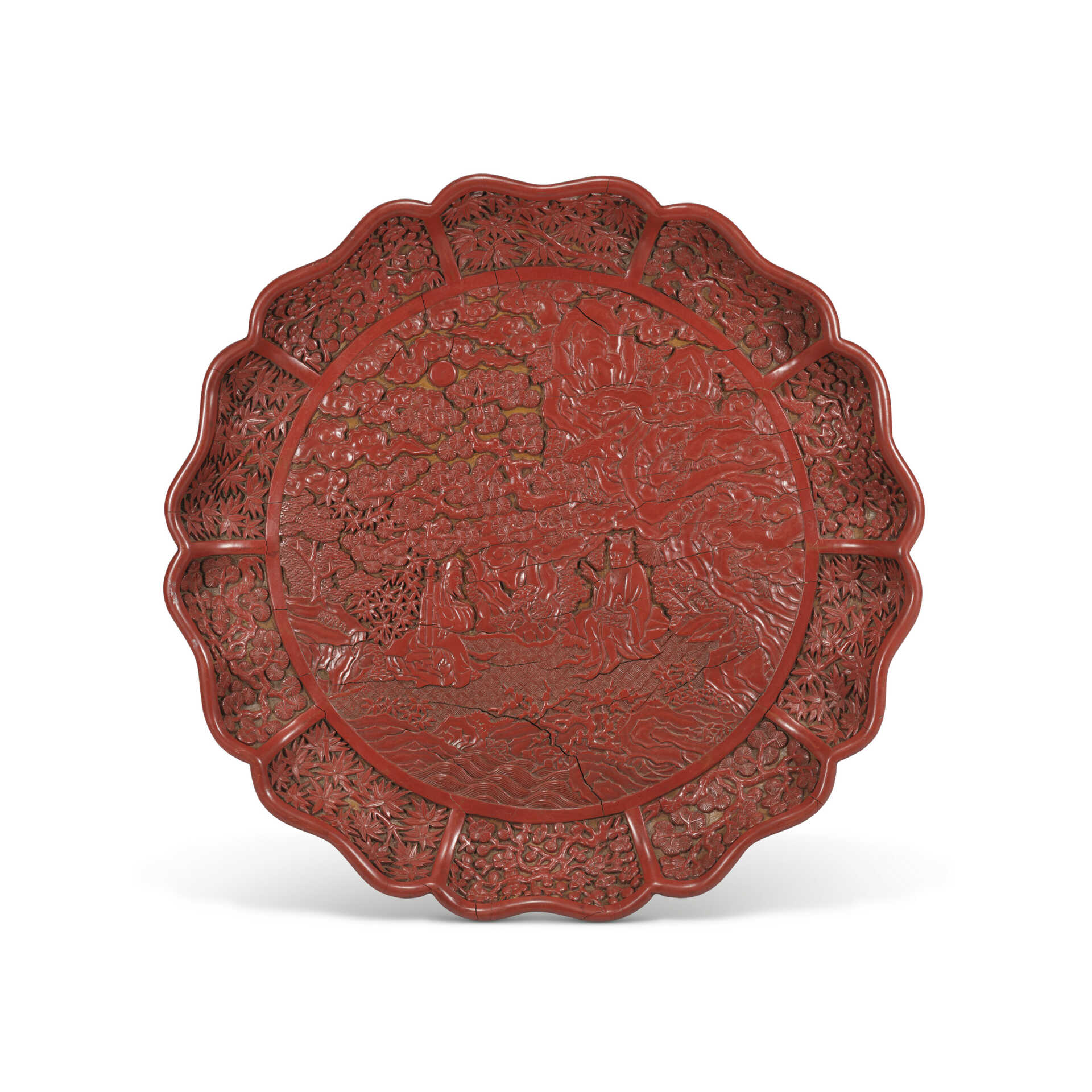 AN IMPORTANT AND EXTREMELY RARE LARGE CARVED CINNABAR LACQUER BRACKET LOBED ‘DAOIST IMMORTALS’ TRAY