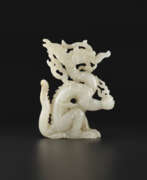 Jin dynasty. A WHITE JADE OPENWORK FIGURE OF A DRAGON