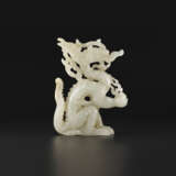 A WHITE JADE OPENWORK FIGURE OF A DRAGON - photo 1