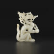 A WHITE JADE OPENWORK FIGURE OF A DRAGON - Сейчас на аукционе