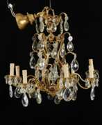 Ceiling lights. Eight-candle chandelier in the Rococo style. France. Early 20th century.