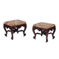 A pair of superb carved mahogany banquettes in the George II style. The turn of the 19th-20th centuries.