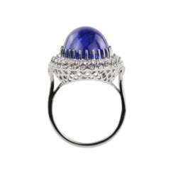 Ring in 18K white gold with tanzanite, cabochon cut, and loose diamonds.