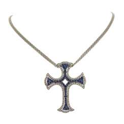 18K white gold cross, Italian workmanship, with sapphires and diamonds.