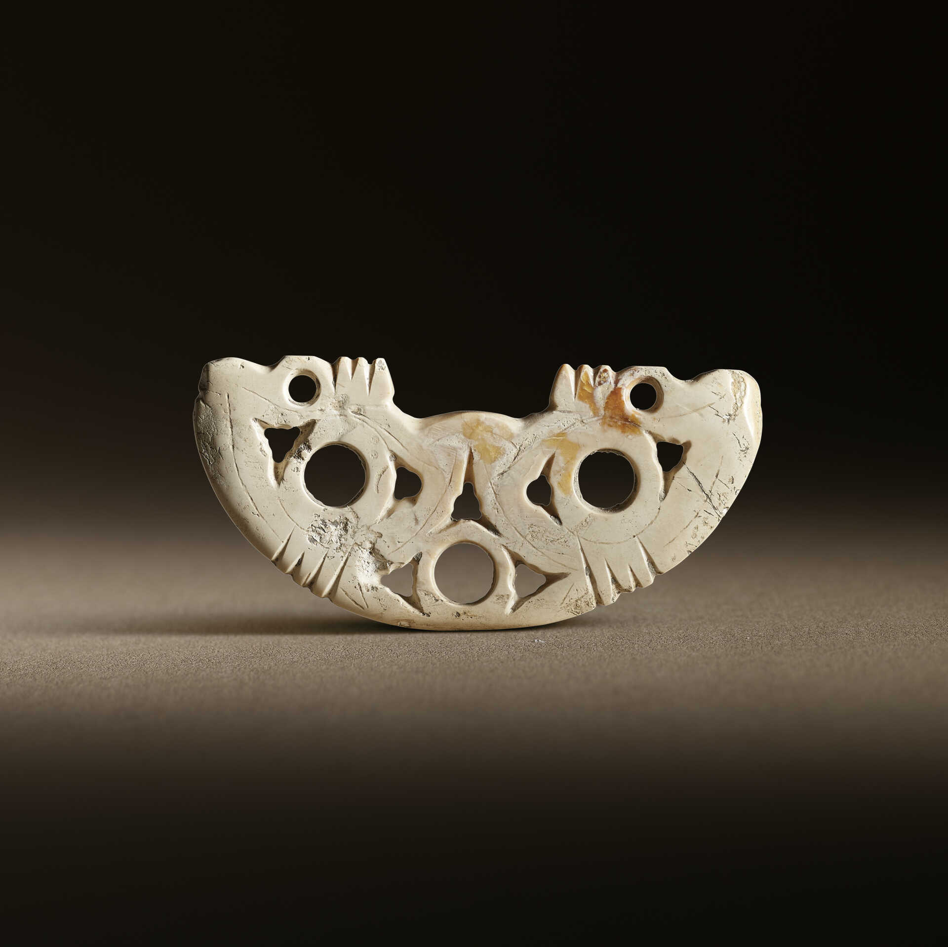 A JADE PIERCED PENDANT, HUANG