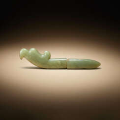 A TWO-SECTIONED CELADON JADE HAWK-HEAD FORM FINIAL