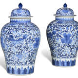 A PAIR OF CHINESE STYLE PORCELAIN BLUE AND WHITE VASES AND COVERS - photo 1