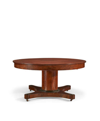 A CENTRAL EUROPEAN MAHOGANY AND PARCEL-EBONIZED CIRCULAR EXTENSION DINING TABLE - photo 1