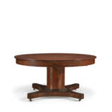 A CENTRAL EUROPEAN MAHOGANY AND PARCEL-EBONIZED CIRCULAR EXTENSION DINING TABLE - photo 1