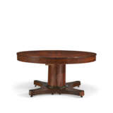 A CENTRAL EUROPEAN MAHOGANY AND PARCEL-EBONIZED CIRCULAR EXTENSION DINING TABLE - photo 2