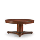 A CENTRAL EUROPEAN MAHOGANY AND PARCEL-EBONIZED CIRCULAR EXTENSION DINING TABLE - photo 3