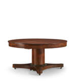 A CENTRAL EUROPEAN MAHOGANY AND PARCEL-EBONIZED CIRCULAR EXTENSION DINING TABLE - photo 4