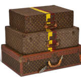 A SET OF THREE: PERSONALIZED MONOGRAM CANVAS HARDSIDED SUITCASES WITH BRASS HARDWARE - photo 1