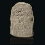 AN EGYPTIAN LIMESTONE ROUND-TOPPED STELE - photo 1