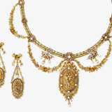 A parure consisting of a necklace and a pair of drop earrings in tricolour gold with small pearls. Paris, circa 1880 - фото 1