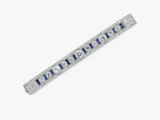 A historical bar pin decorated with diamonds and blue sapphires. Probably USA, 1925s