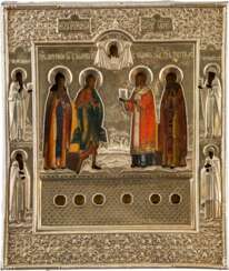 A RARE ICON SHOWING FOUR SELECTED SAINTS AND SIX RELICS WITH SILVER-GILT RIZA