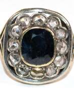 Каталог товаров. Ring, 750er GG, geprüft, ca. 5,6 g, Diamanten in Silber gefasst von ca. 0,85 ct. und dunkelblauer Saphir ca. 1,0 x 0,8 cm, RG 50, Innendurchmesser 15,9 mm