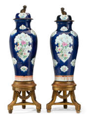 A MASSIVE PAIR OF CHINESE EXPORT PORCELAIN FAMILLE ROSE BLUE-GROUND SOLDIER VASES AND COVERS