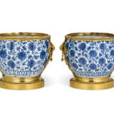 A PAIR OF ORMOLU-MOUNTED CHINESE PORCELAIN BLUE AND WHITE CACHE-POTS - photo 1