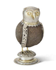 A GERMAN PARCEL-GILT SILVER-MOUNTED COCONUT CUP IN THE THE FORM OF AN OWL