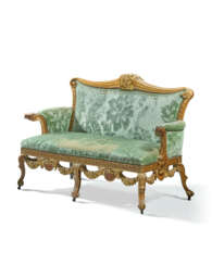 A GEORGE II WALNUT AND PARCEL-GILT SETTEE