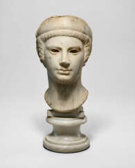 A ROMAN MARBLE ARCHAISTIC HEAD OF A GODDESS